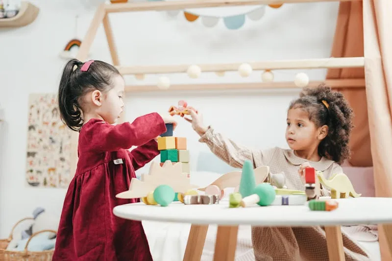 Child building a tower with wooden blocks