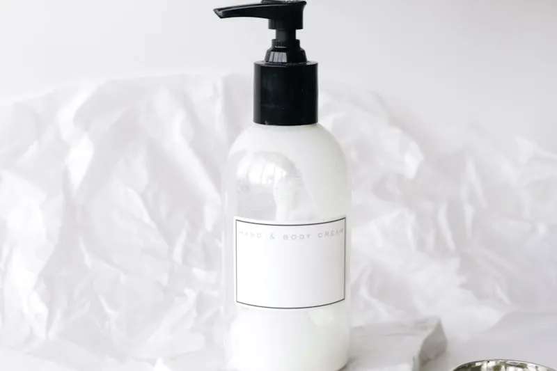 SPF50 sun protection product next to a retinol serum on bathroom shelf