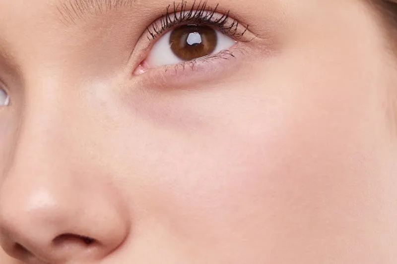 Application of long-wear lipstick on a bride's lips using a lip liner as full base, demonstrating the blotting technique for all-day wear