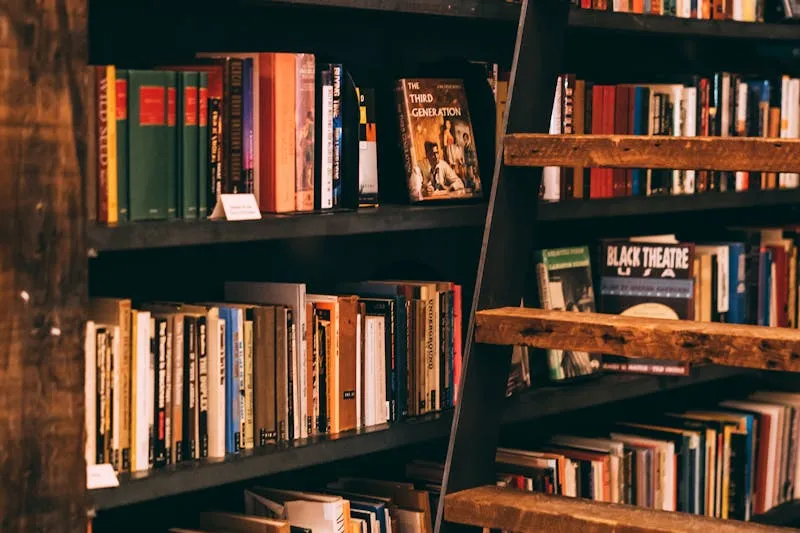 Book selection for club — pile of novels with voting sticky notes, titles written in a notebook