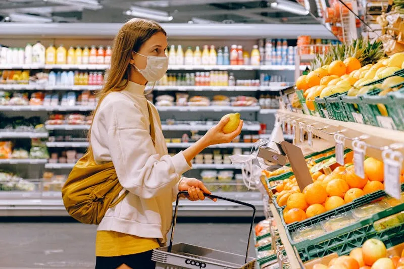 Woman carefully reading nutritional labels in a supermarket