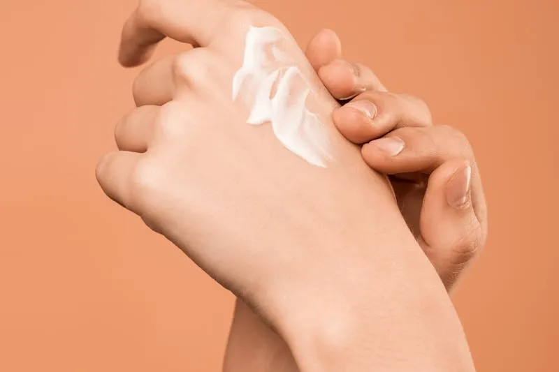 Applying foundation with a stipple brush on bare skin
