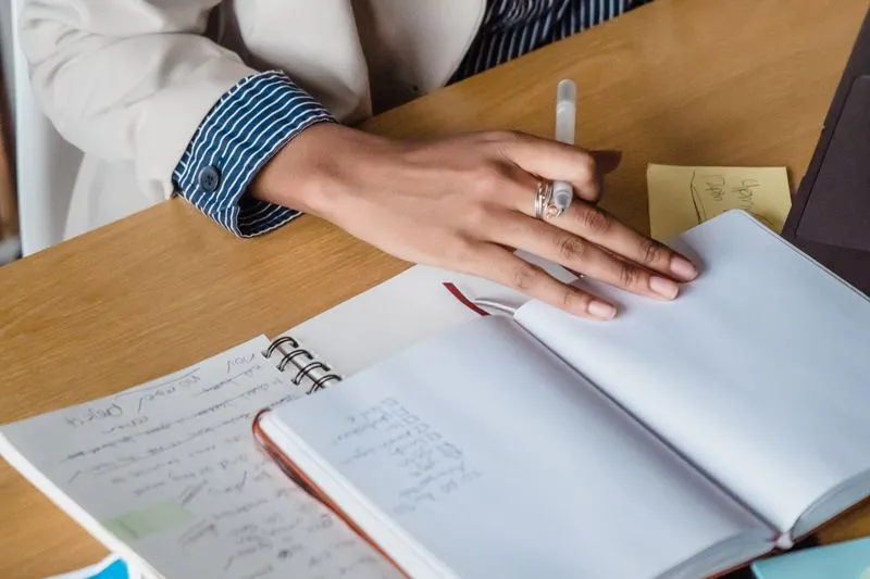 Woman writing in a notebook at her desk