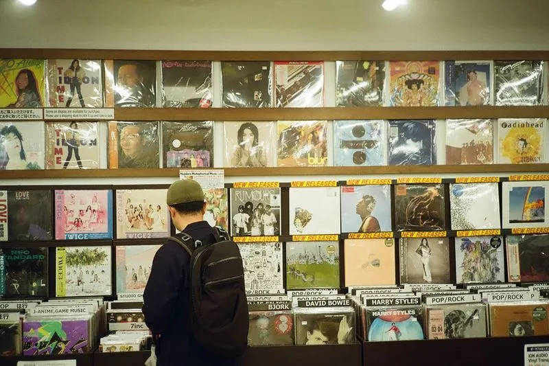 Customer browsing crates of vinyl records in an independent record shop