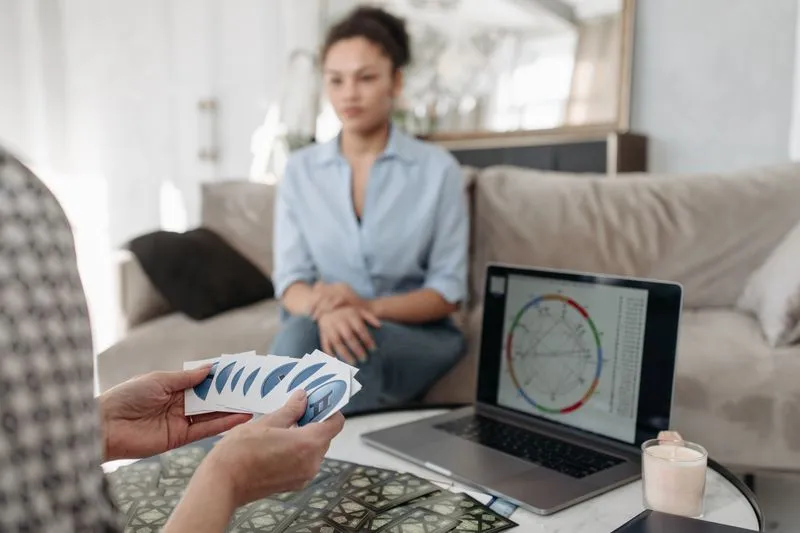 A birth chart consultation: a practitioner talks through the chart shown on a laptop