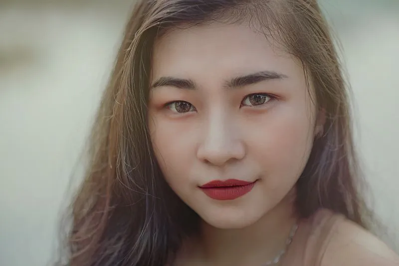 Close-up of deep red lips, sharp edges and precise make-up