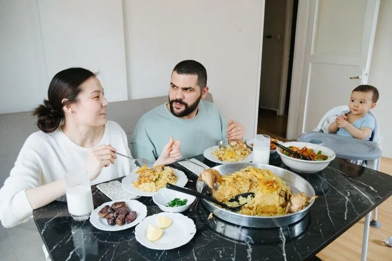 Baby sitting at the family table sharing a meal
