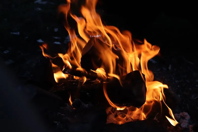 Bright flames from a wood fire burning at night