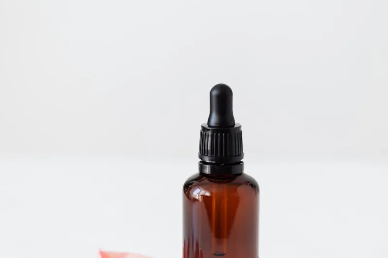 Amber glass dropper bottle against a white background