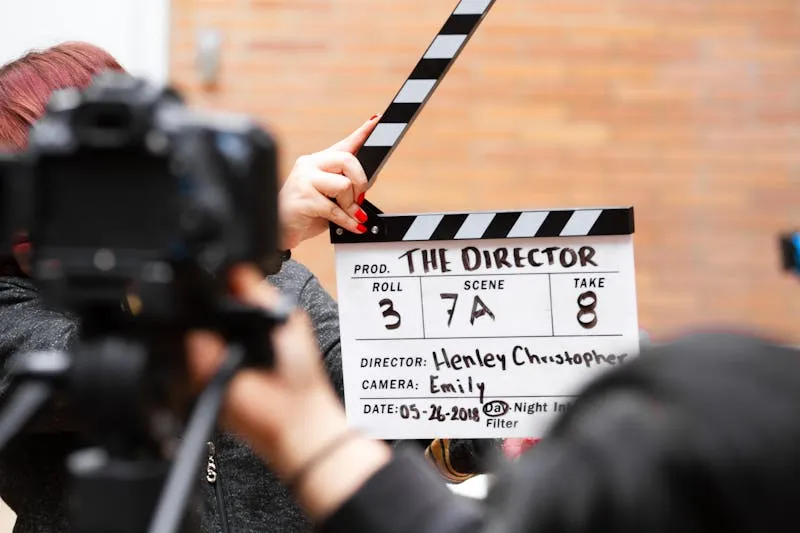 Film clapperboard held up in front of a camera on set