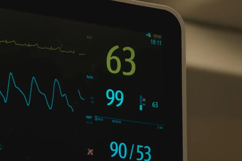 Patient monitor displaying pulse, oxygen saturation and blood pressure