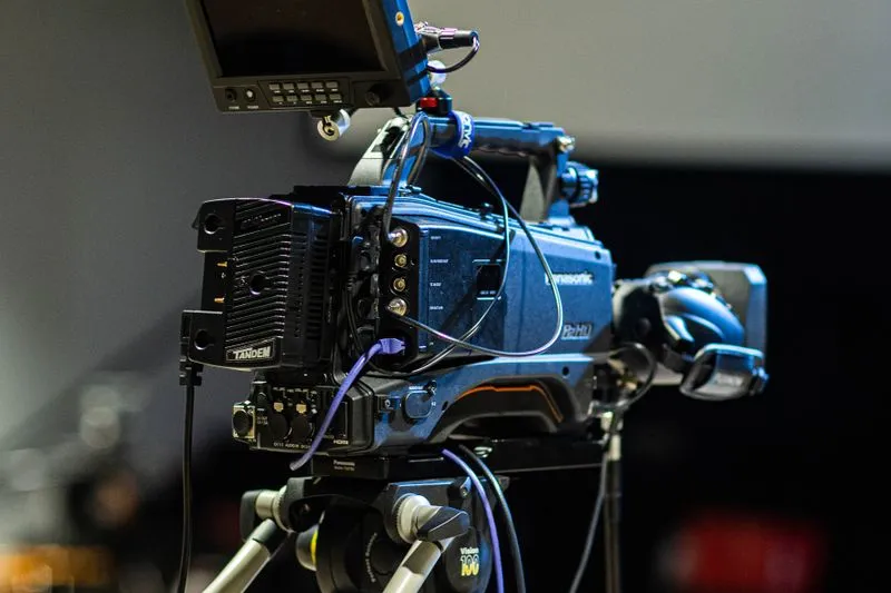 Professional television camera on a tripod, with its monitor and cables
