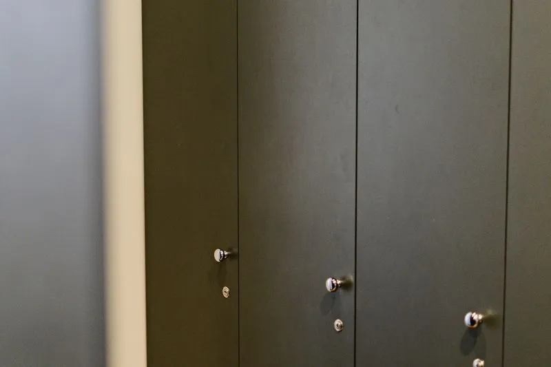 Closed dark grey locker doors, each with its own small key lock