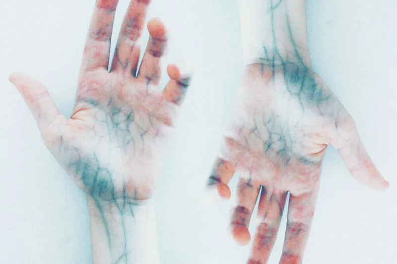 Two open hands, palms up, with bluish veins showing all the way to the wrists