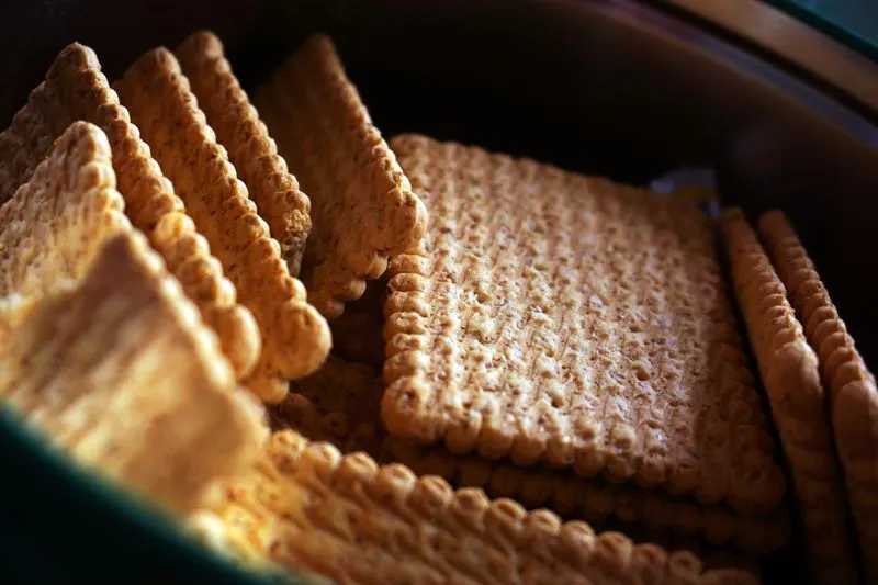 Plain crackers stacked closely in a tin, ready to nibble on first thing in the morning