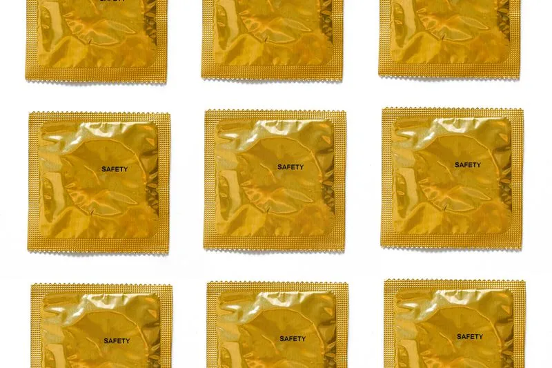 Rows of individually wrapped condoms, the word ‘safety’ printed on each packet