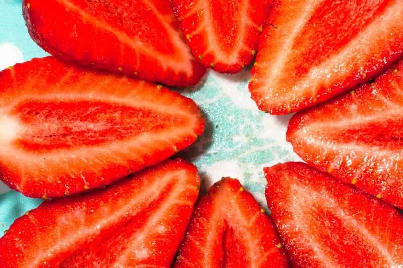 Halved strawberries arranged in a circle, cut side facing up