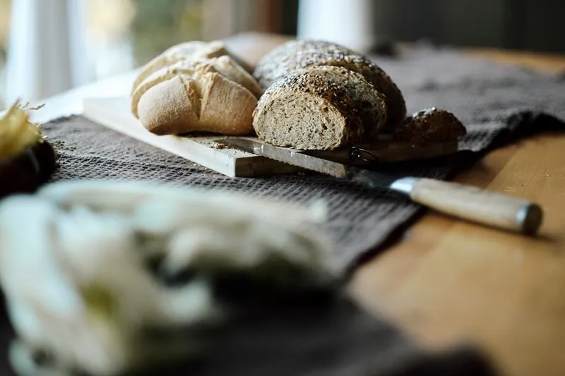Seeded wholemeal loaf cut into slices on a chopping board