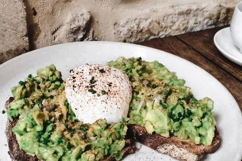 Wholemeal toast topped with smashed avocado and a poached egg