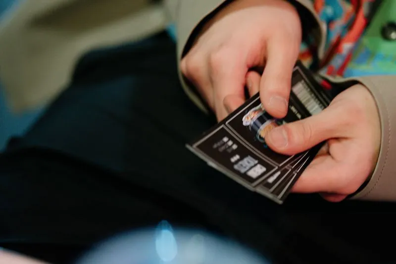 Close-up of hands holding a fan of cinema tickets