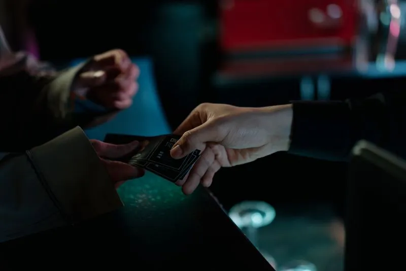 Close-up of a cinema ticket being handed over at the counter