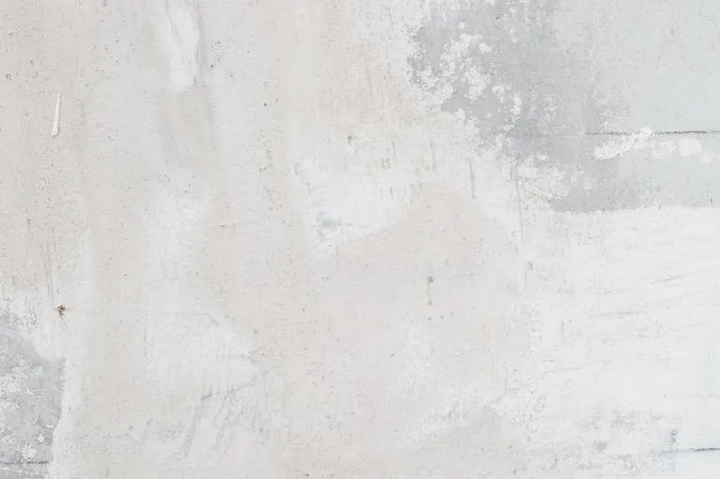 Woman focused on using a drill to mount a wall shelf