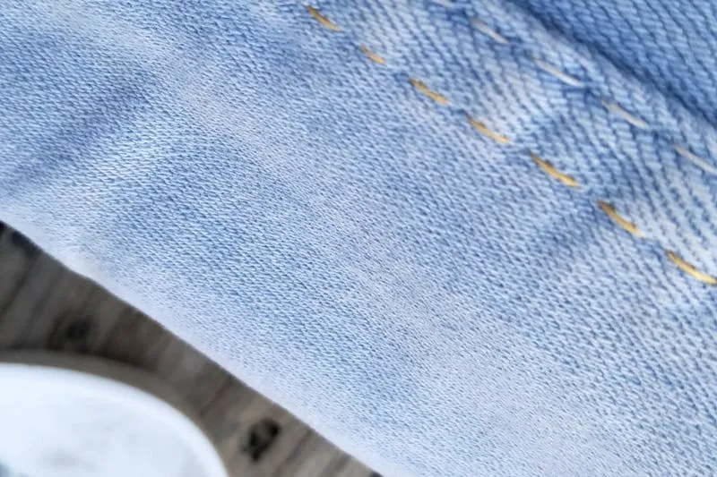 Geometric patterned tights worn with a black dress