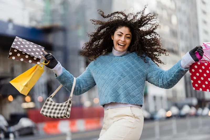 Woman sorting through her clothes with three piles