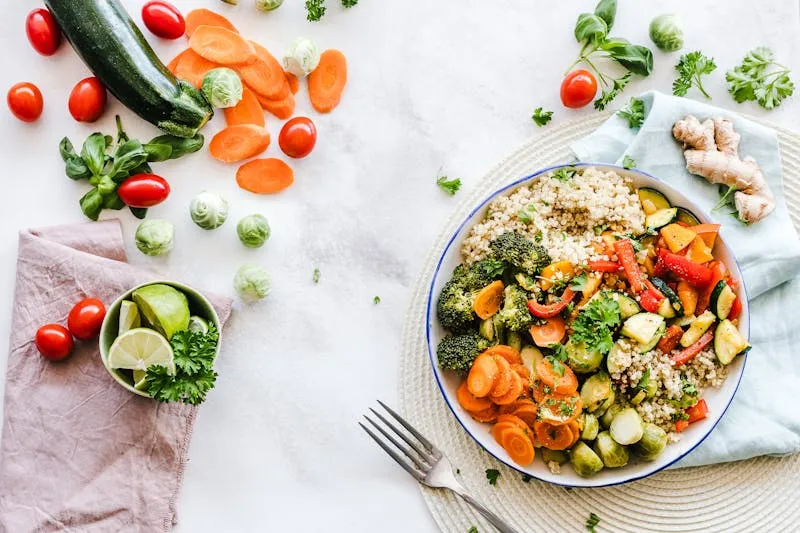 Colourful Mediterranean table with olive oil, vegetables and fish