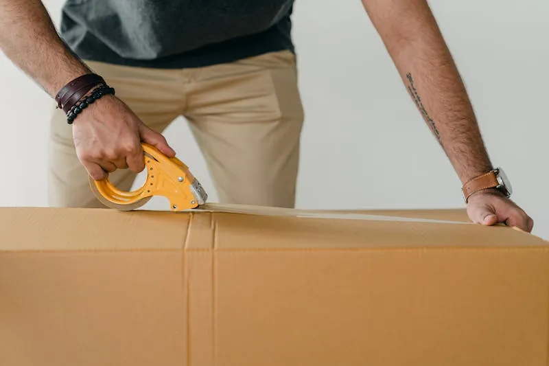Sealing a large moving box with a tape dispenser
