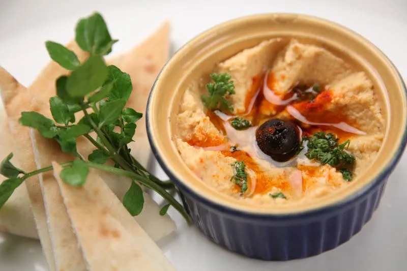 Creamy homemade hummus topped with whole chickpeas and olive oil