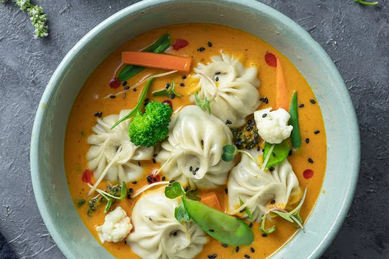 Golden fried kibbeh on a platter with fresh mint leaves