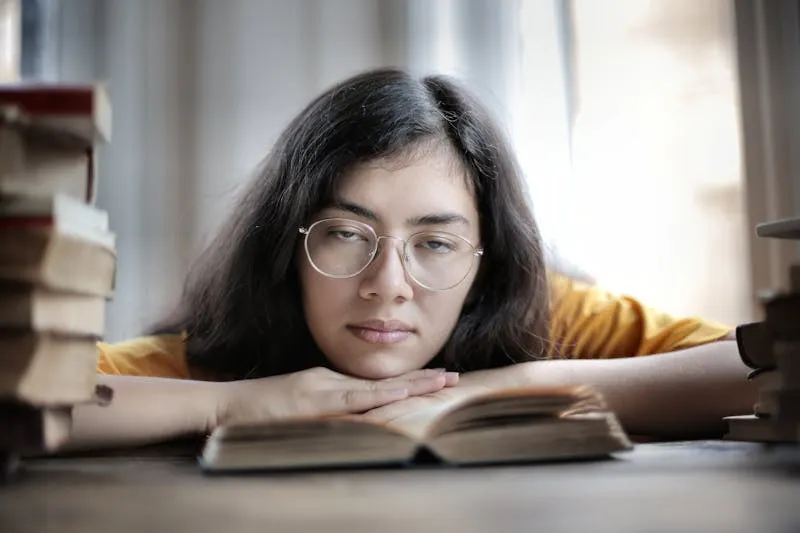 Woman absorbed in reading a novel on a sofa