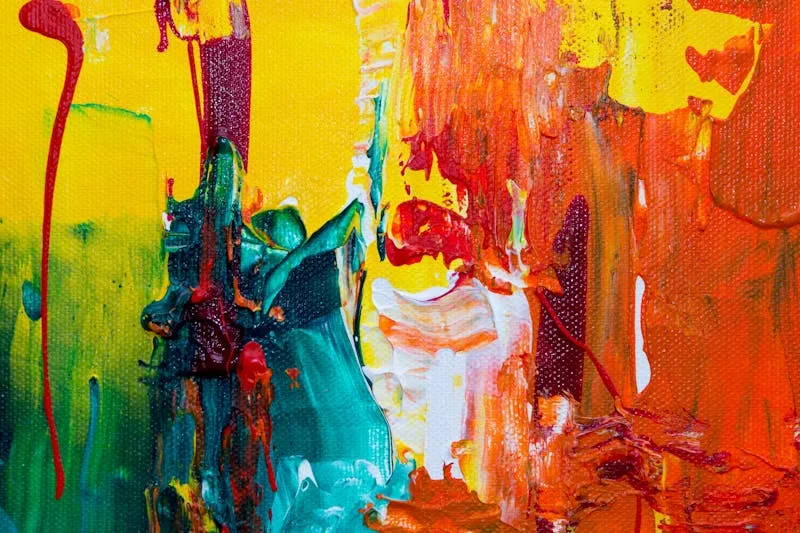 Colour wheel with paint samples and brushes on a white background