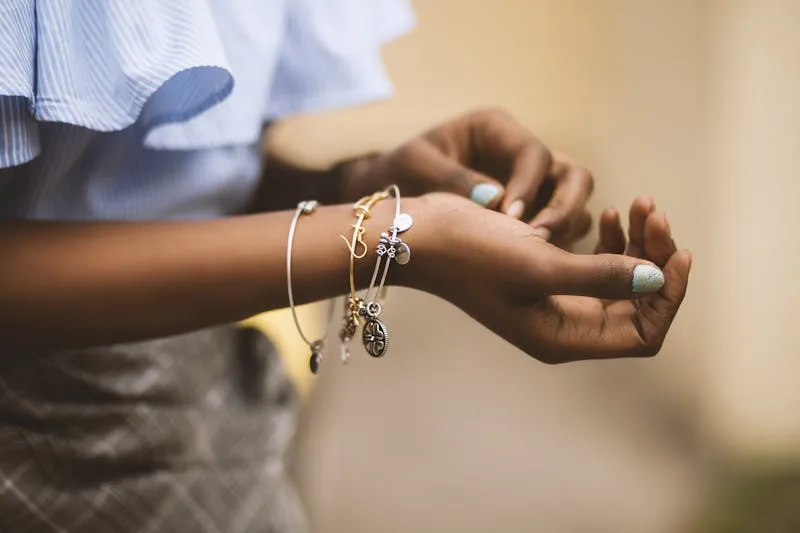 Close-up of layered gold bangles on a wrist